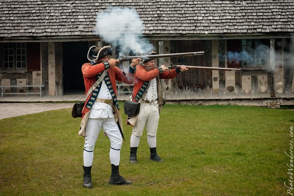 Two redcoats fire in unison