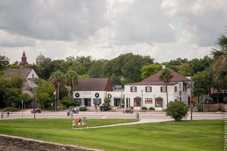 View of St. Augustine old town from the fort, with church steeple, palm trees and colonial buildings