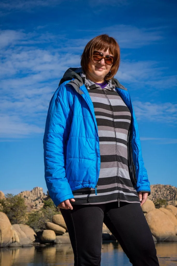 Julia standing confidently in front of Watson Lake